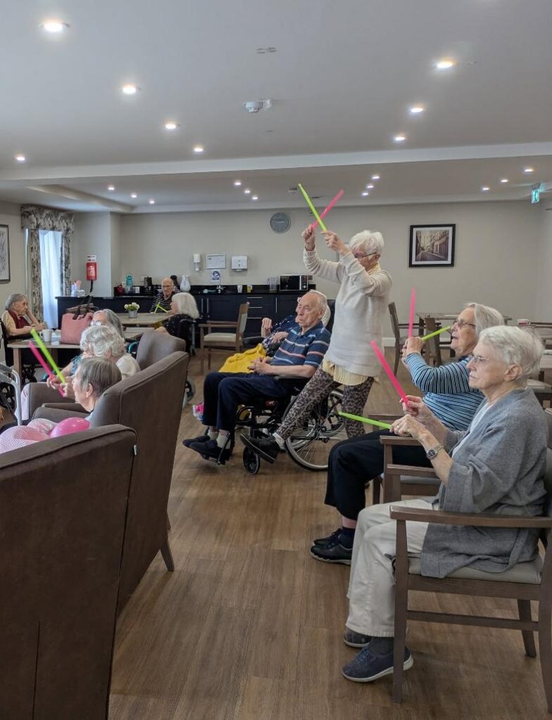 older adults with colourful drum sticks