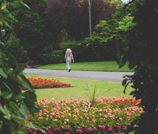 person walking in a garden