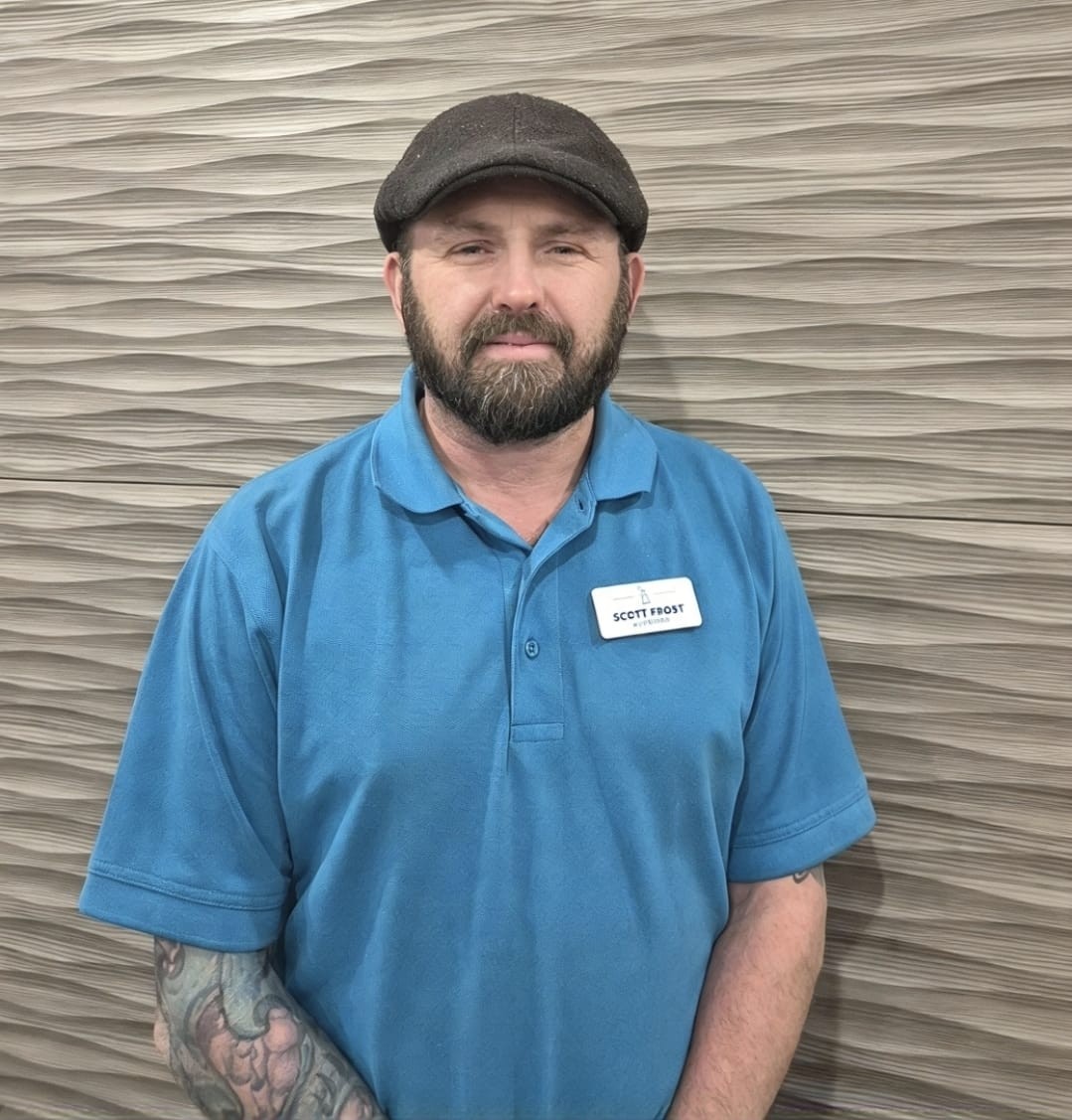 man in blue shirt posing for staff photo